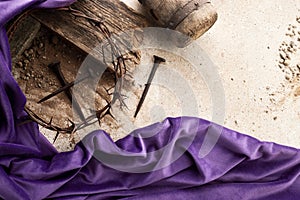 Crucifixion Of Jesus Christ. Cross With three Nails And Crown Of Thorns on ground