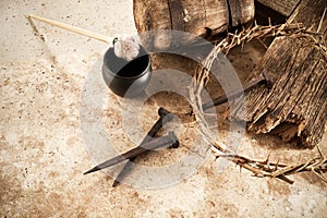 Crucifixion Of Jesus Christ. Cross With three Nails And Crown Of Thorns on ground