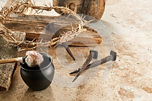 Crucifixion Of Jesus Christ. Cross With three Nails And Crown Of Thorns on ground