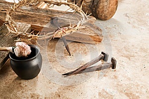 Crucifixion Of Jesus Christ. Cross With three Nails And Crown Of Thorns on ground