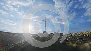 Crucifixion of Jesus Christ with thorn crown, nails, hammer and a rope against beautiful sky and flying pigeons, tilt