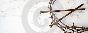 Crucifixion Of Jesus / religion easter background - Crown Of Thorns and rusty old nails on white marble marble Ground or table or