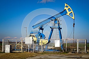 Crude oil extraction well. Pumpjack extracting petroleum.