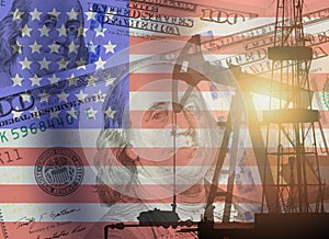 Crude oil and petroleum concept. Pump jack, US 100 USD dollar notes and American flag background