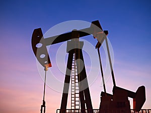 Crude oil pump or oil rig with twilight sky