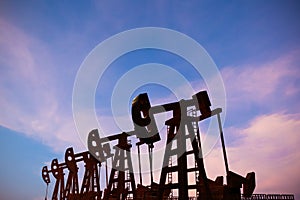 Crude oil pump or oil rig with twilight sky