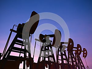 Crude oil pump or oil rig with twilight sky