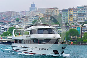 Cruise boat on Bosphorus strait on rainy spring day Istanbul city Turkey