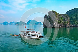 Cruise boat near rock islands in Halong Bay