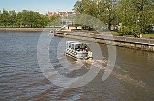 Cruise boat with people sailing on Pregolya