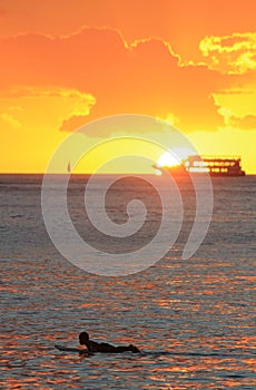 The Cruise boat and the surfer during the sunset