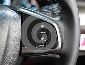 Cruise control buttons on modern car and speed limitation