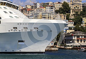 Cruise line ship side with small ship.