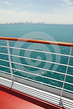 Cruise liner deck with red floor and wooden rail