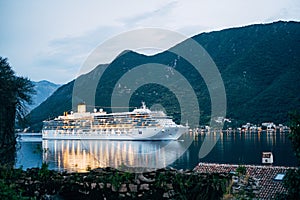 The cruise liner sails at night on the Bay of Kotor in Montenegro, near Perast.