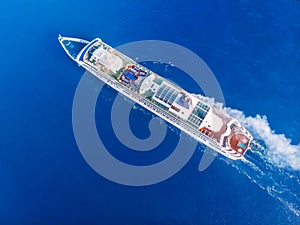 Cruise liner ship across ocean with blue water. Aerial top view. Concept travel tour