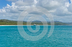 Cruise liner, ship in tropical sea with exotic island on the background