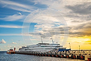 Cruise motor ships moored at the pier at sunset. Excursion tours on rivers and lakes of Russia