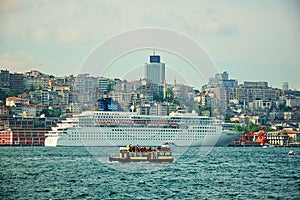 Cruise Ship against small tourist boat in Istanbul Port