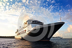 Cruise ship at anchor during the sunset, outside the harbour of Bora Bora, French Polynesia, South Pacific