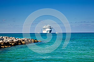 Cruise Ship Anchored on Tropical Island photo