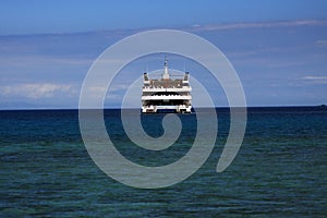 Cruise ship anchored in the tropics photo