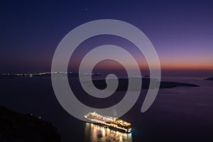 Cruise ship at berth at the blue hour, in the bay, at the island of Santorini, Greece