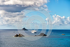 Cruise ship in blue sea on cloudy sky in gustavia, st.barts. Travel by water, discovery and adventure. Vessel and marine transport