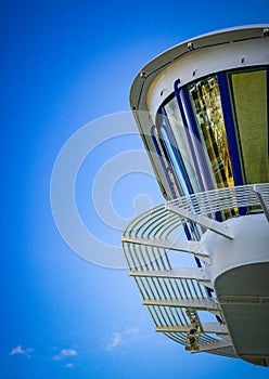 Cruise ship bridge surrounded by blue sky, where the officers steer the ship