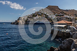 Cruise ship and buildings around pier in Hydra Island