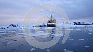 Cruise ship in calm waters of Deception Bay, Antarctica at twilight