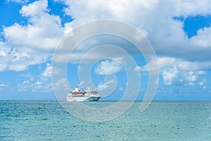 Cruise ship on Caribbean Sea close to paradise beach. Tropical travel concept and destination for vacation. Recreation and
