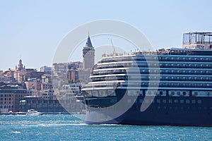 Cruise ship in the city port in the city port for tourist travel on a sunny day. The historic galata tower, which is the symbol of