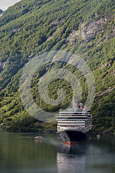 Cruise ship docked at the end of a fjord in a small Norwegian town