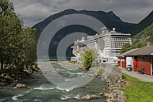 Cruise ship docked at the end of a fjord in a small Norwegian town