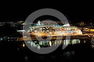 Cruise ship docked at ocean terminal at night