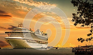 Cruise ship docked at port on sunset. Sunset over a sea