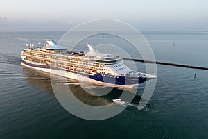 Cruise ship enters Government Cut and Port Miami at sunrise on calm summer day.