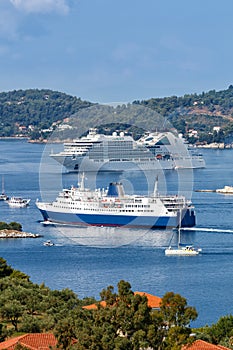 Cruise ship, ferry and boats portrait format in the Mediterranean Sea Aegean island of Skiathos, Greece