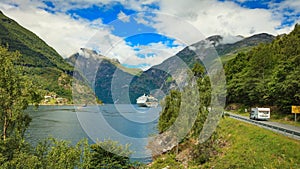 Cruise ship on fjord and camper on road, Norway