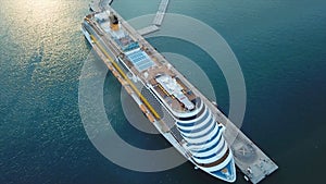 Cruise ship at harbor. Cruise ship in the blue sea. Stock. Aerial view of beautiful large white ship at sunset. Colorful