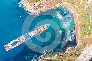 Cruise ship in the lagoon of a tropical island, top aerial view