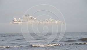 Cruise Ship Leaving Port Of Galveston in a stripe of the dense fog.