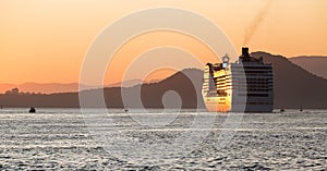 A cruise ship leaving the port of Santos, Brazil, during a beautiful summer sunset