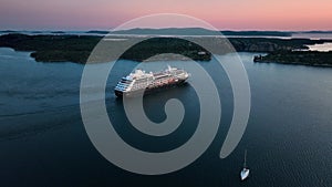 A cruise ship leaving the port of Shibenik in Croatia ata sunset