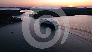 A cruise ship leaving the port of Shibenik in Croatia ata sunset