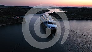 A cruise ship leaving the port of Shibenik in Croatia ata sunset