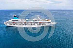 Cruise ship liner sails in the blue sea leaving a plume, seascape. Aerial view The concept of sea travel, cruises