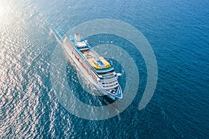 Cruise ship liner sails in the sea leaving a plume on the surface of the water seascape. Aerial view The concept of sea travel,