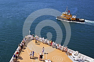 Cruise ship passengers on the deck arriving in Caribbean port